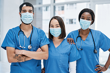medical team wearing blue uniform and face masks