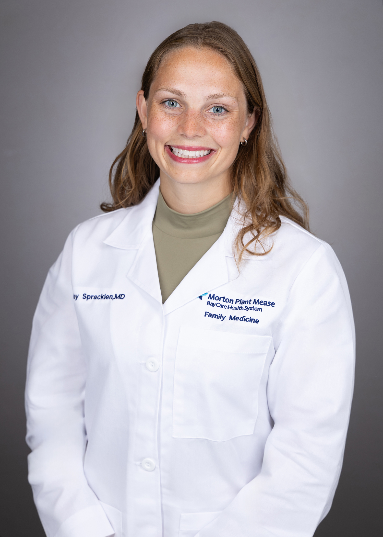 Henley Spracklen smiling wearing a medical white coat