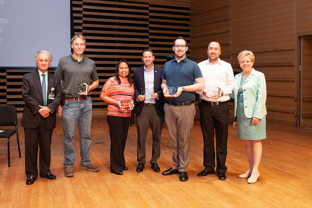 Members of the COPH team stand with USF Health Executive Vice President Charles Lockwood (far left) and USF President Rhea Law (far right). (Photo by Andrew Mason)