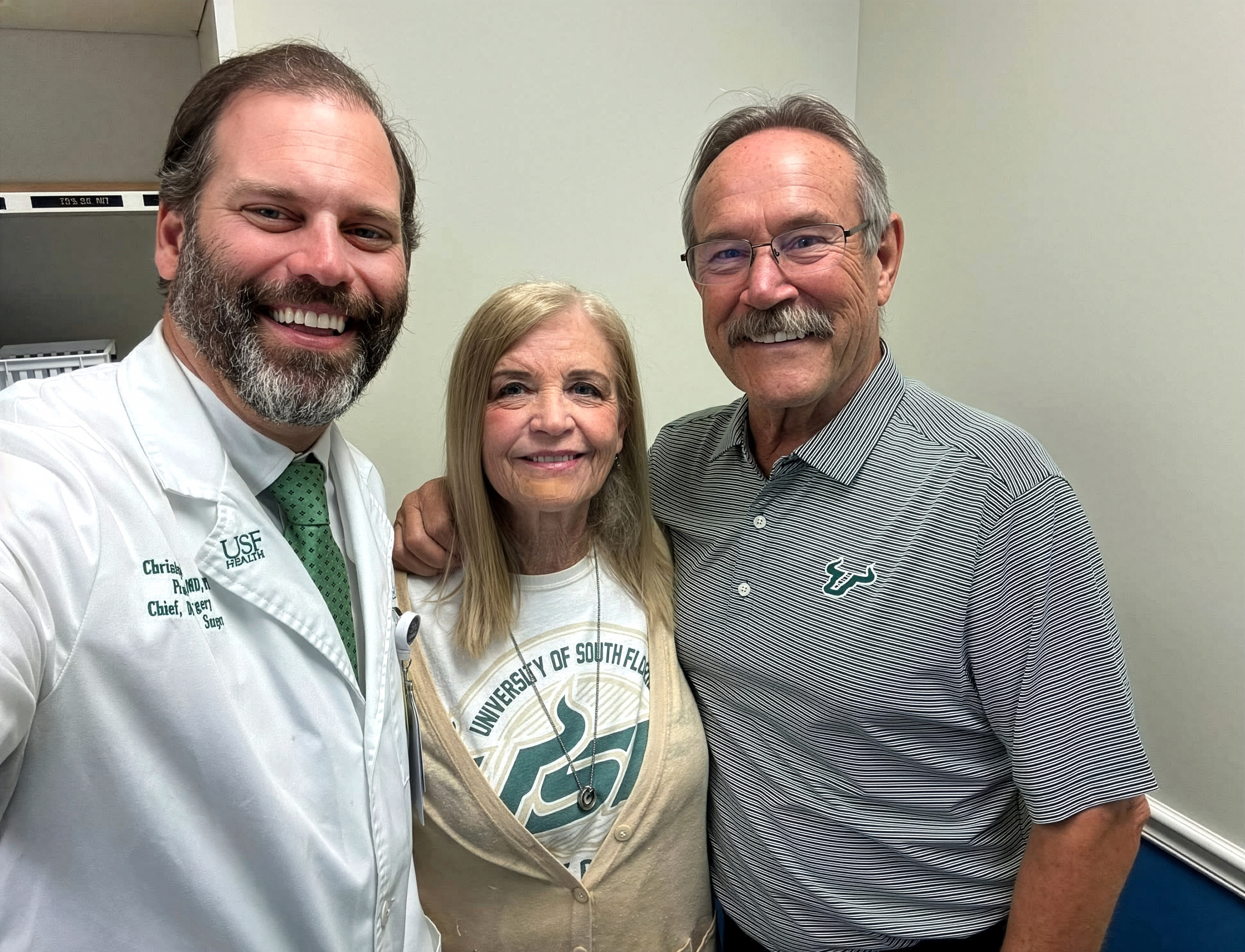 Dr. Ducoin, Karin and Bob Johnson smiling for a selfie