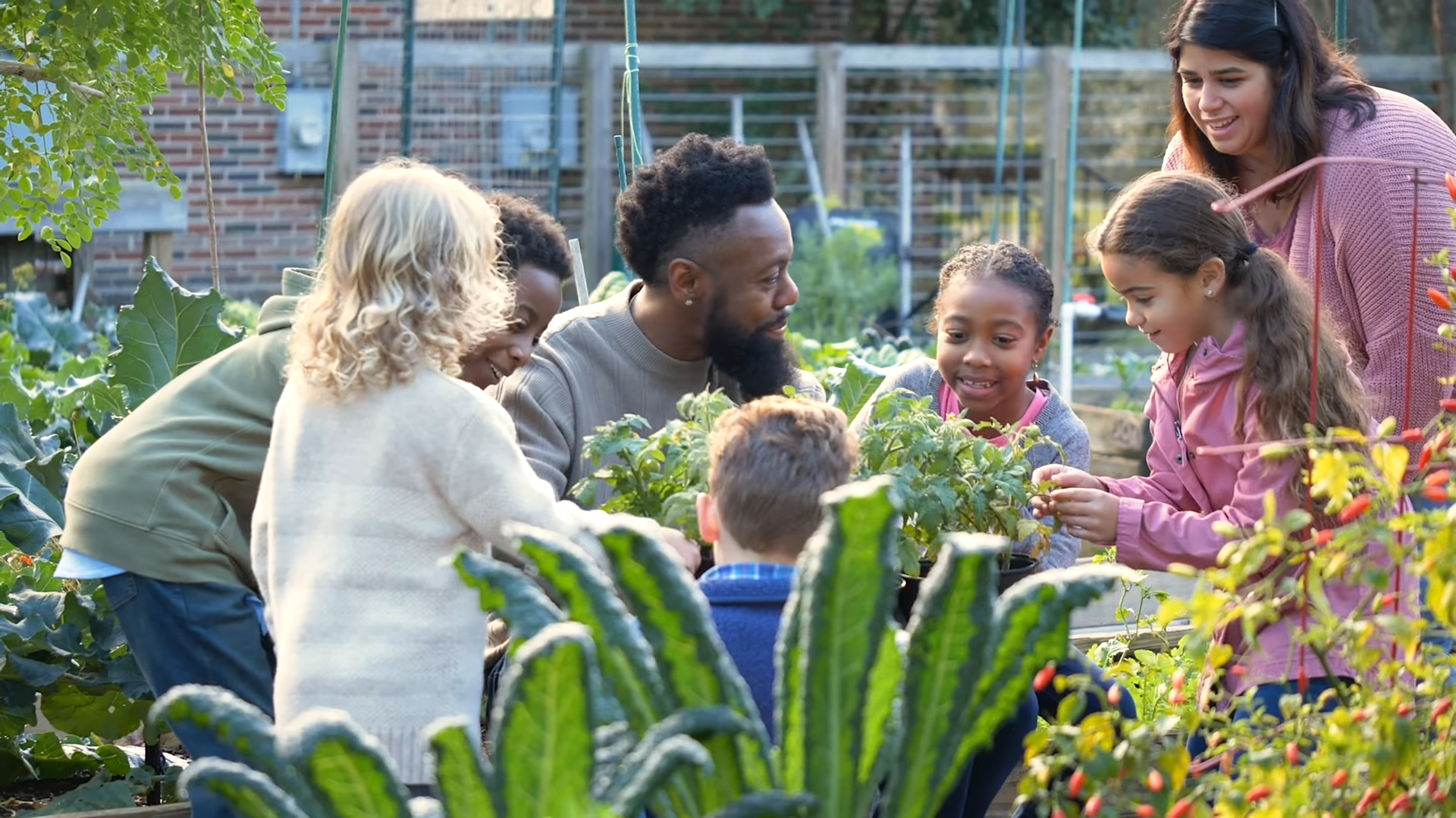 A group of people of all ages in a garden
