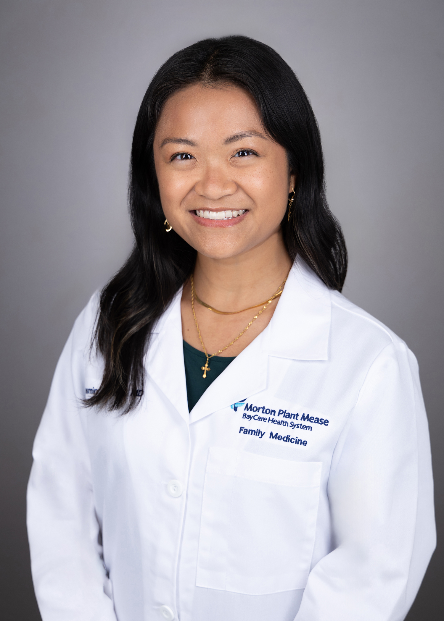 Jasmin Lamba smiling wearing a medical white coat