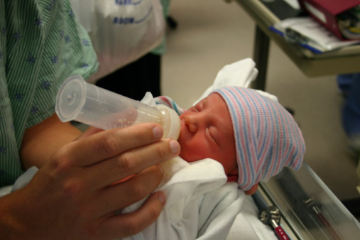 Preemie baby being fed