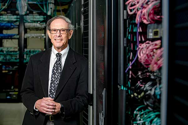 Dr. Jeffrey Krischer standing in computer server room