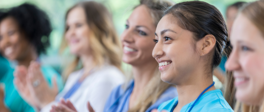 Public health professionals smiling and clapping