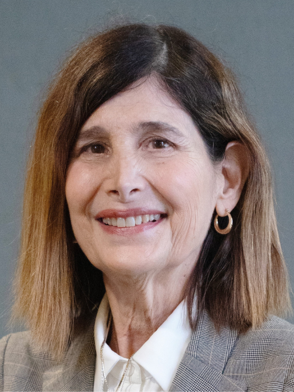 A headshot of Dr. Karen Liller smiling in front of a grey backdrop