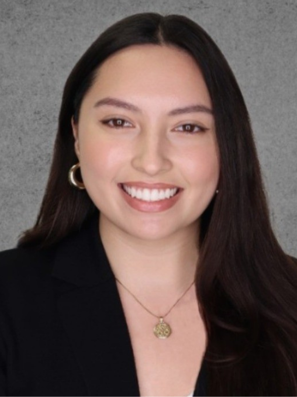 Headshot of Coralyn Bamper in front of a grey backdrop