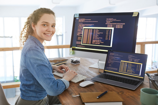 A person sitting at a desk in front of a computer screen