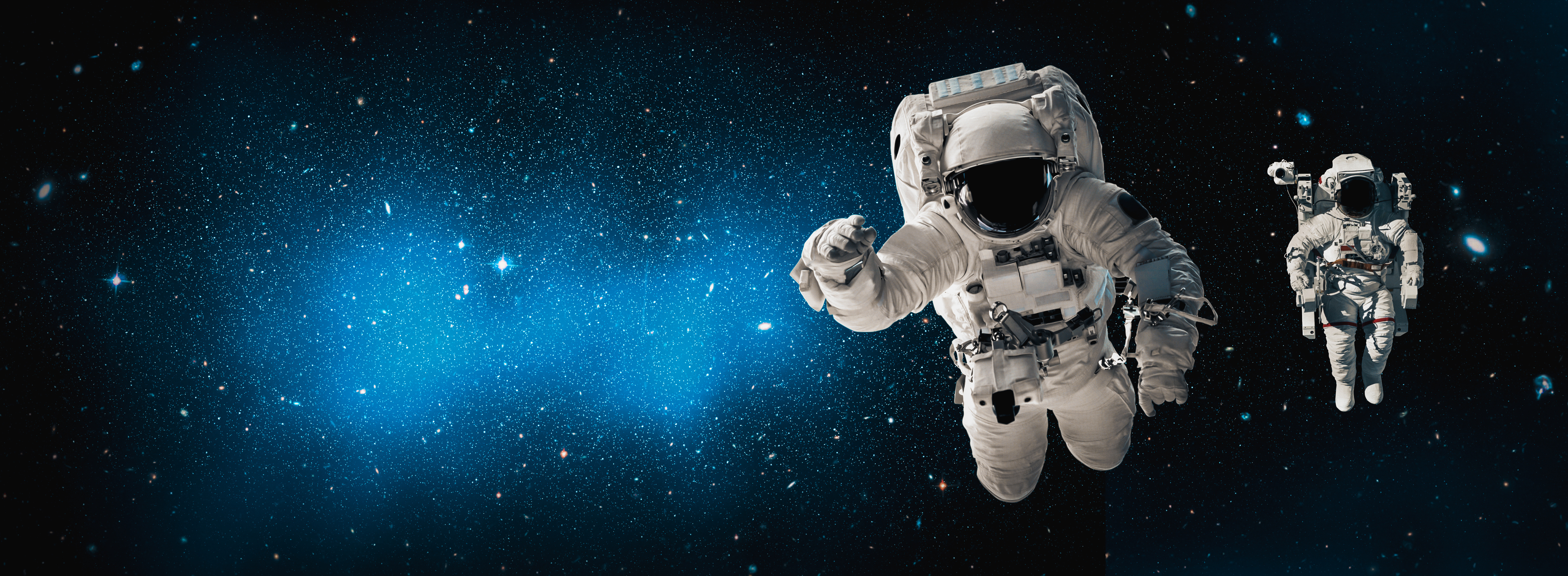 two astronauts floating in outer space