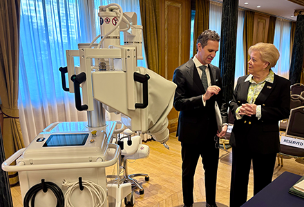 Dr. Panetta and USF President Rhea Law standing in from of robot operating machine