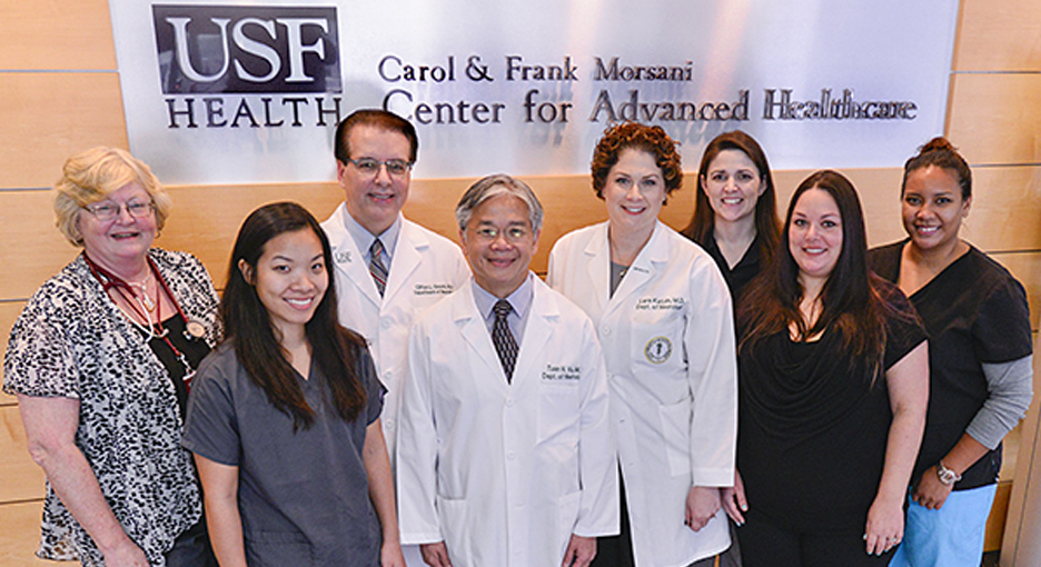 Neuromuscular team in front of USF-Health sign