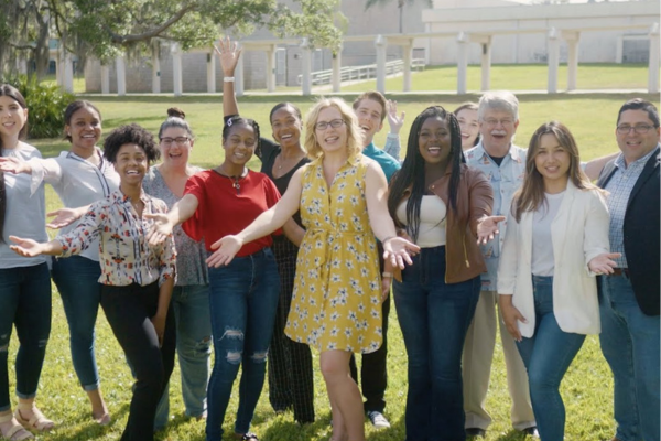A group of faculty and staff representing MCH at USF COPH stands in front of a building, showcasing camaraderie and community spirit.