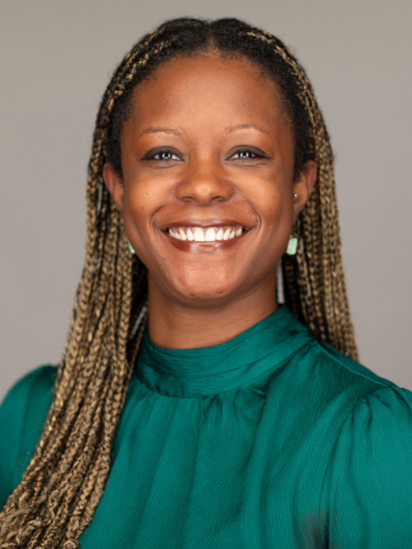 Headshot of Arabel Severe in front of a grey backdrop