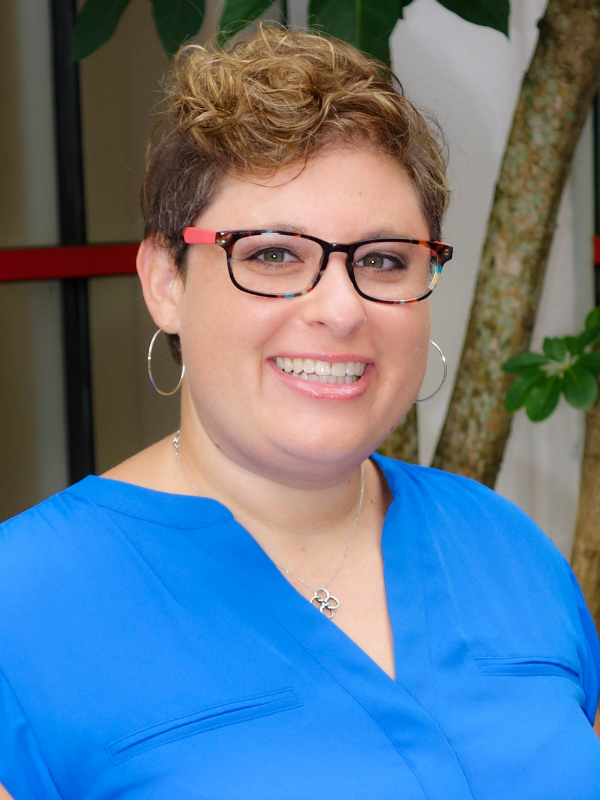 A headshot of Dr. Alison Oberne smiling in an outdoor setting