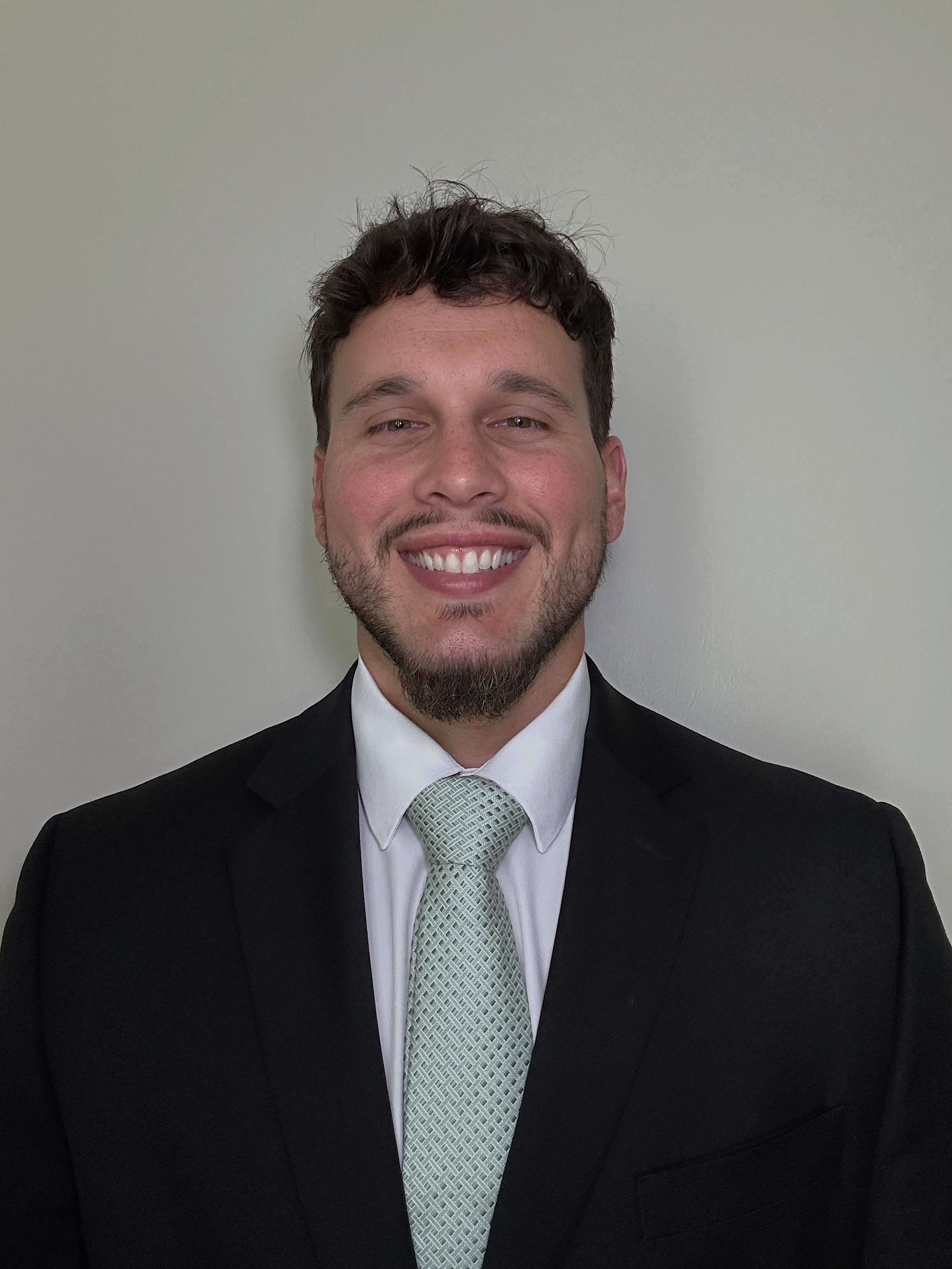 headshot of Valdes in suit with tie