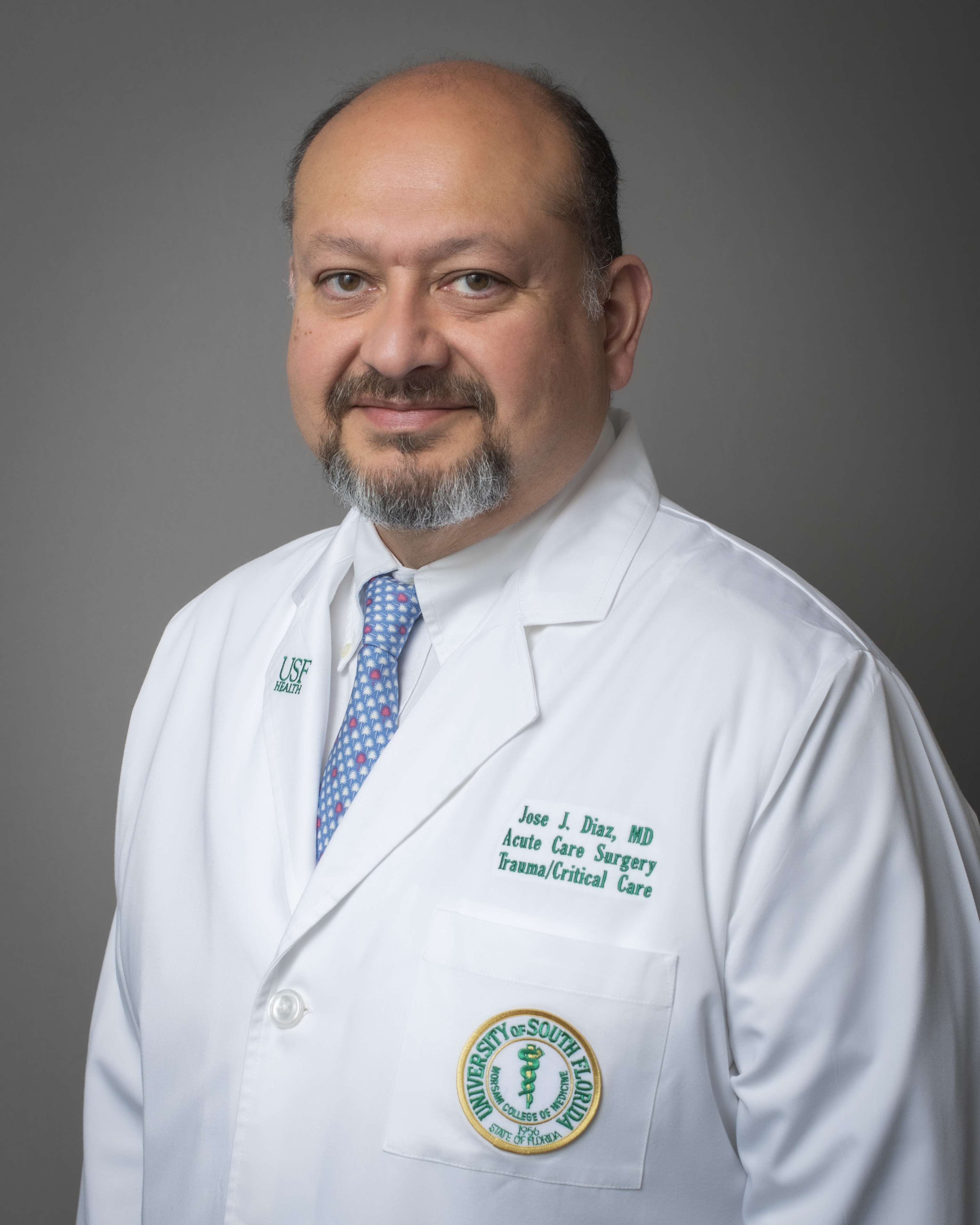 Dr. Jose Diaz in a surgical white coat