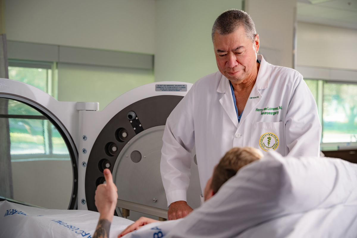 Dr. Harry Van Loveren stands with a patient going into Hyperbaric Oxygen Therapy