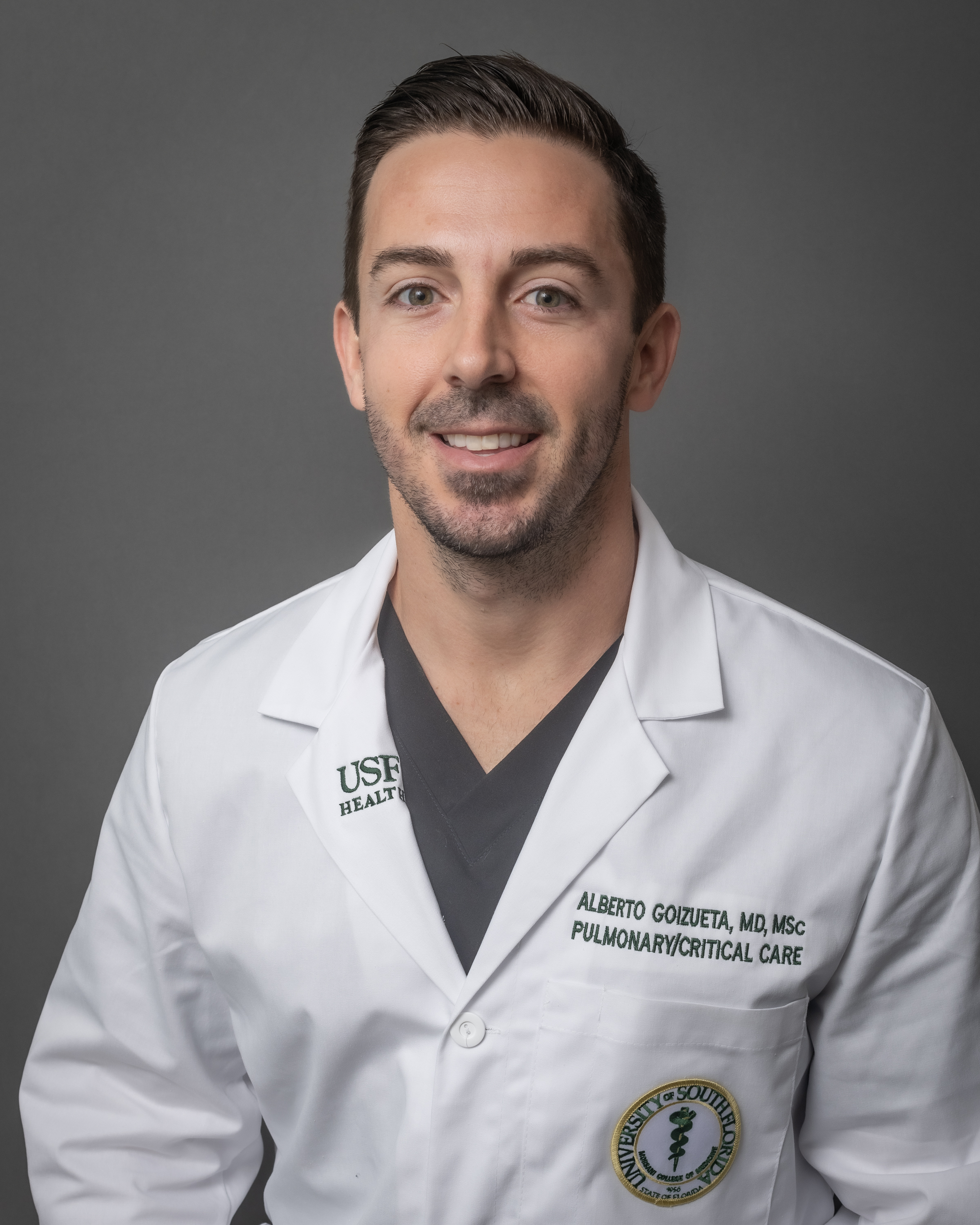 Dr. Alberto Goizueta smiling in a medical white coat