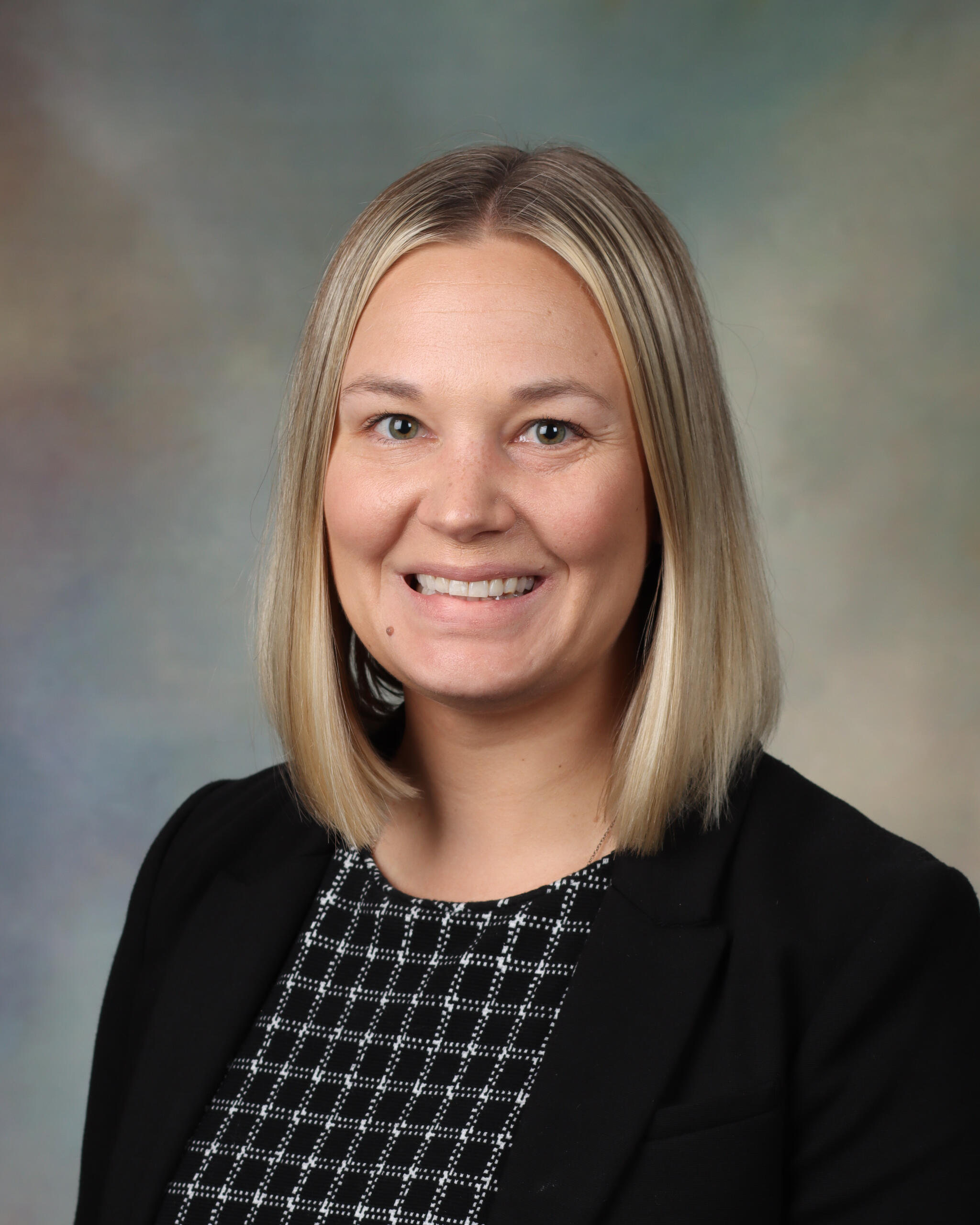 Headshot of Eleanor Johnson, MD, MPH. She is wearing a black blazer over a black patterned shirt. 