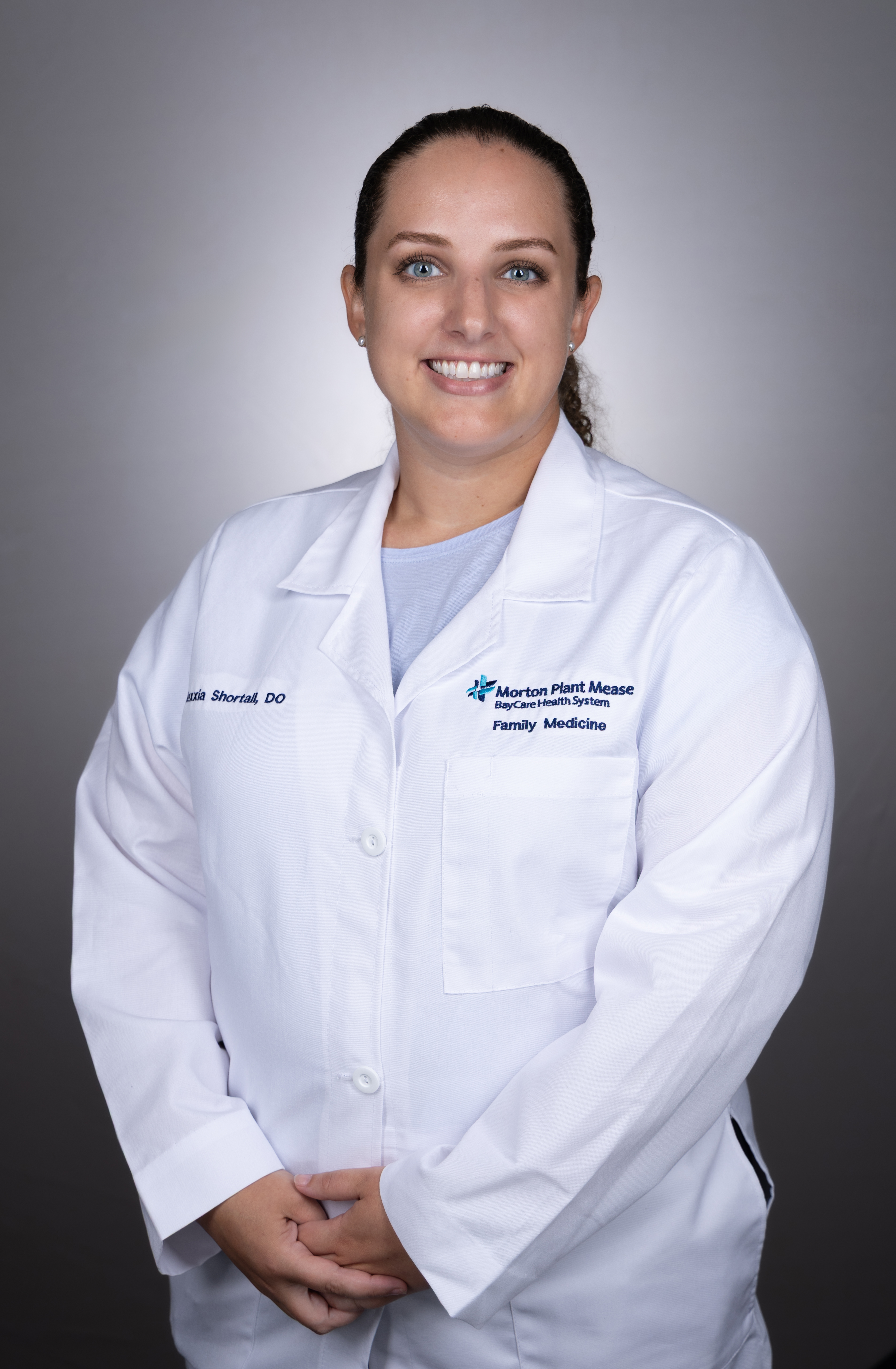 Alexxia Shortall smiling wearing a medical white coat