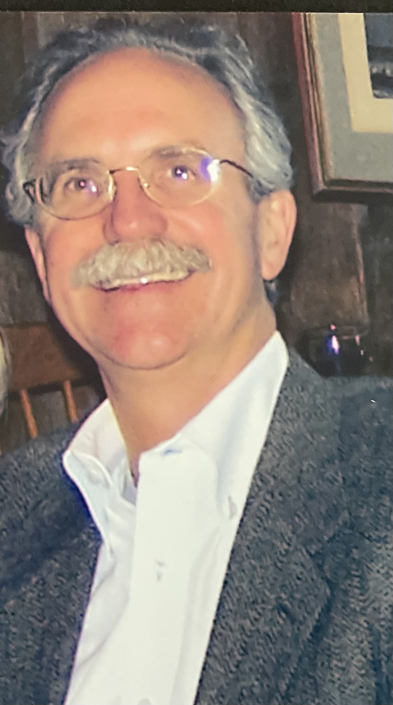 Dr Marquardt smiling wearing a grey suit jacket and white dress shirt