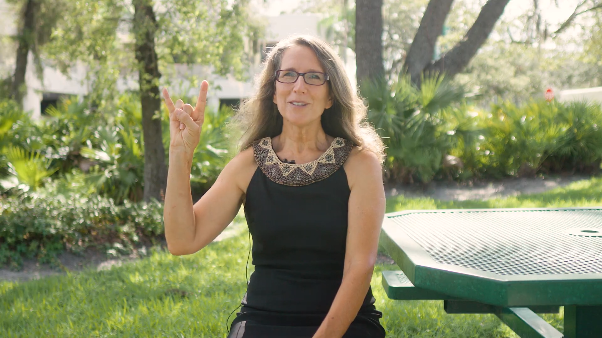 A woman holding up the “Go Bulls!” hand symbol