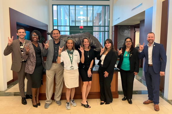 A group of COPH alumni posing together and smiling