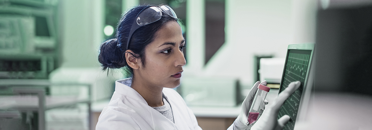 Researcher looking at screen in the lab