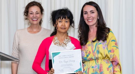 Dr. Rays Jiang posing for a photo with Stephanie Haas and Lauren Gstalder of the WLP. They are smiling and Dr. Jiang is holding a certificate award.