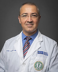 Lucian Lozonschi headshot with a medical white coat, blue shirt and multi-colored tie