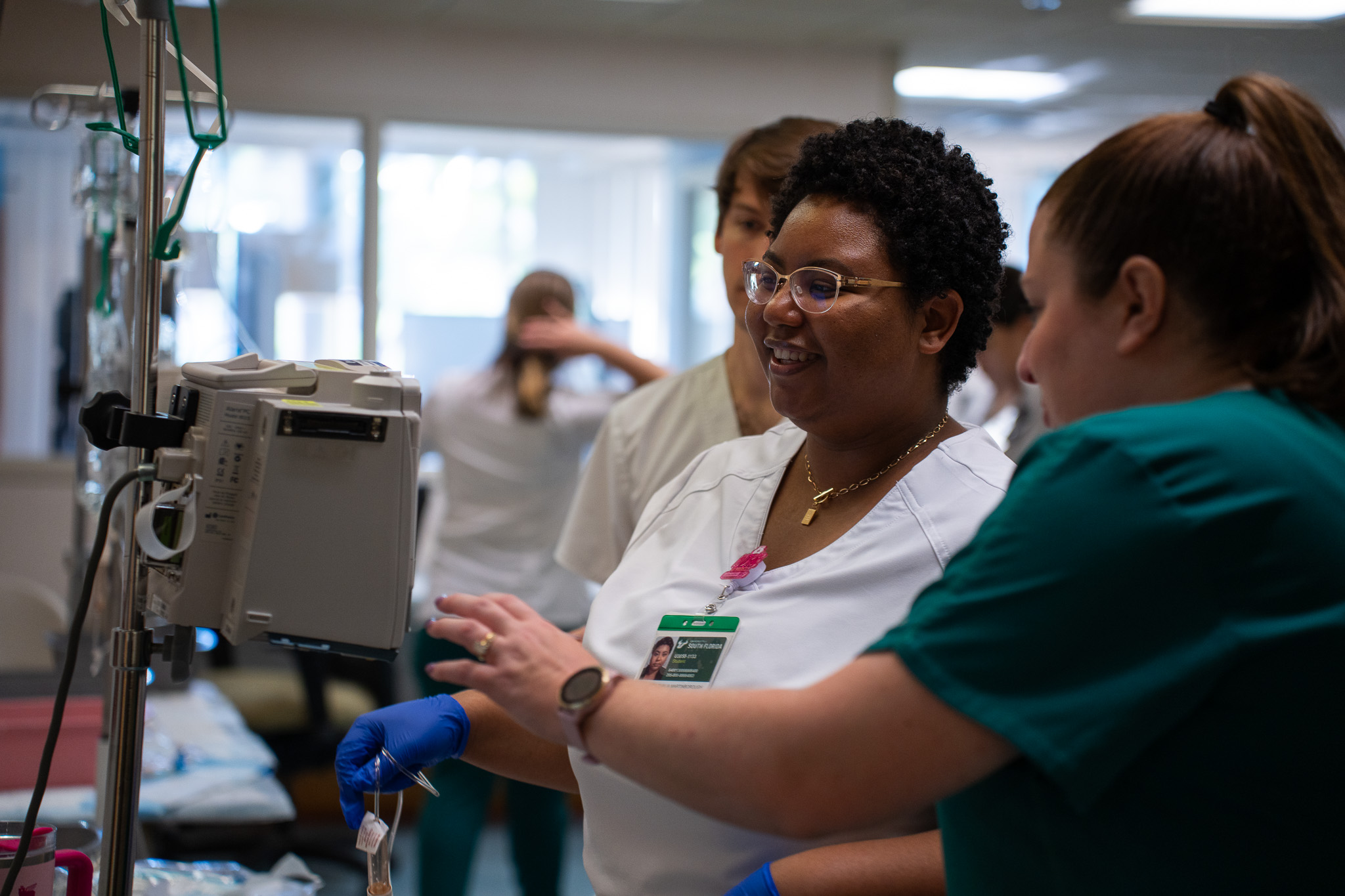 nursing students working in a sim lab