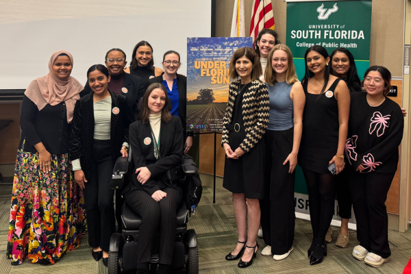 Dr. Liller posing for a photo with members of the Activist Lab