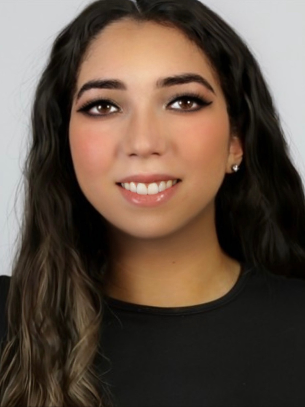 A headshot of Jazlynn Marie Hirschhorn smiling in front of a white backdrop.