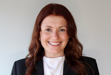 Madeline Helm smiling wearing a white blouse with a black blazer