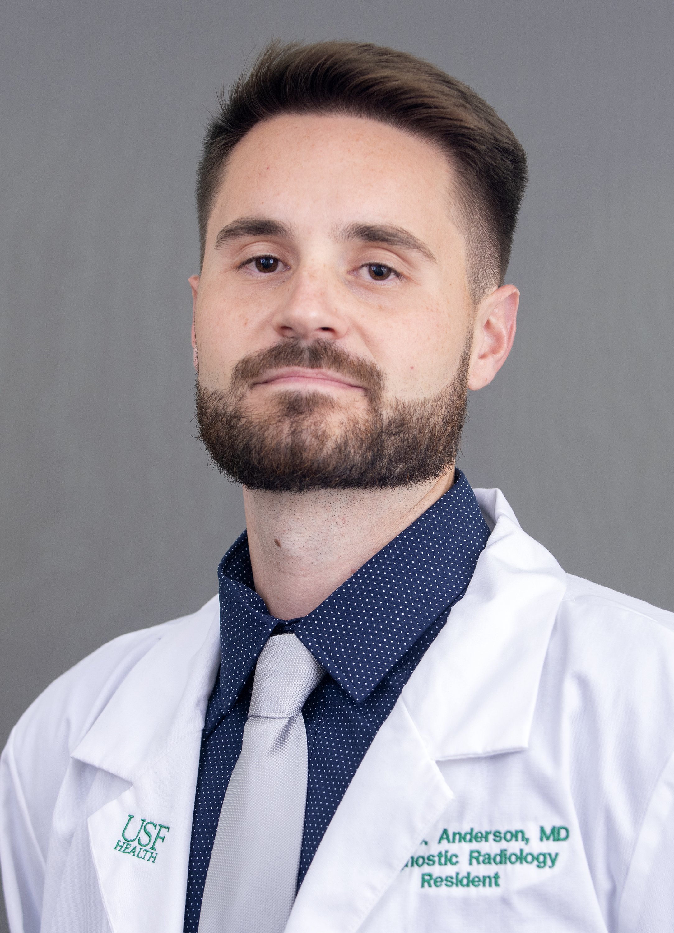 Dr. Tyler Anderson white coat headshot