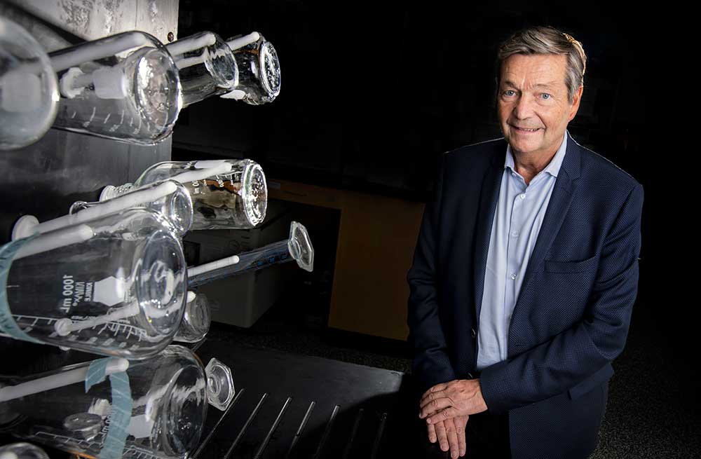 Dr. Christian Bréchot sitting with lab equipment