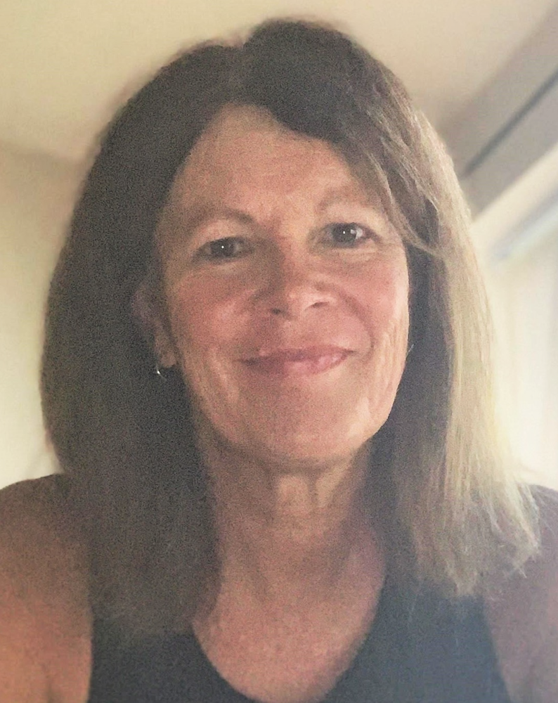 front camera image of smiling woman wearing black shirt 