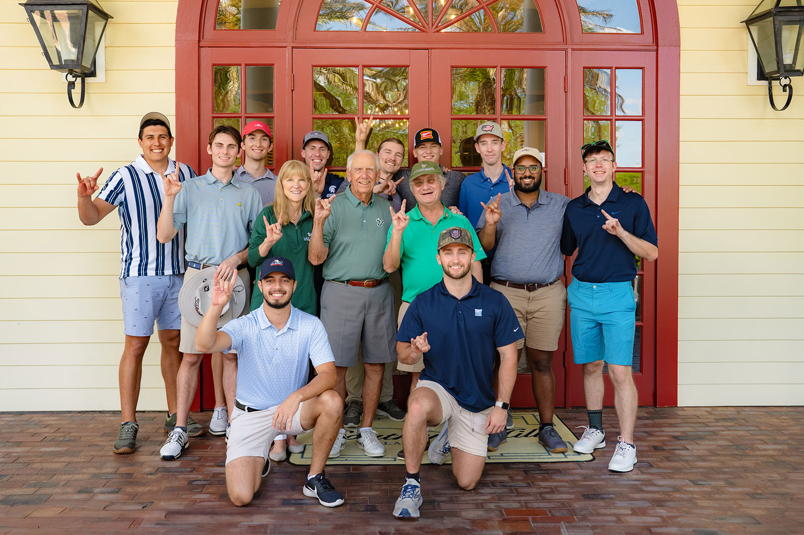 Dr. Lockwood, Frank Morsani, Dr. Riddle and eleven other members in attendance for the USF Health 50th Anniversary Gold Tournament all signing the Bull Horns.