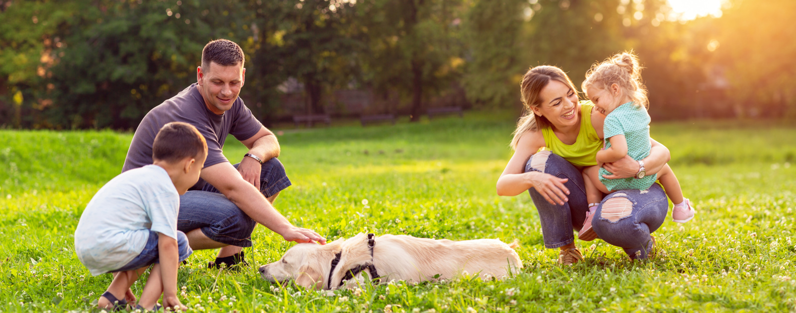 Family enjoying the park with dog 