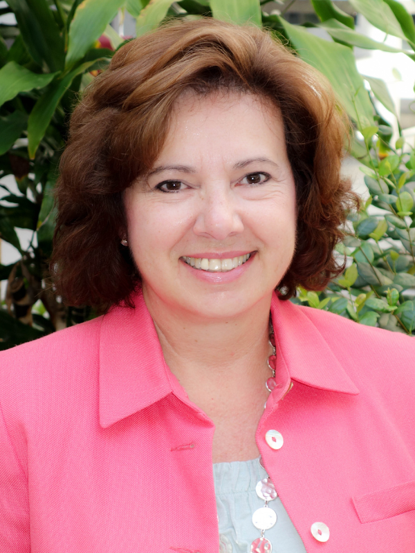 A headshot of Dr. Janice Zgibor smiling in an outdoor setting
