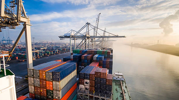 An aerial shot of a body of water and shipping containers