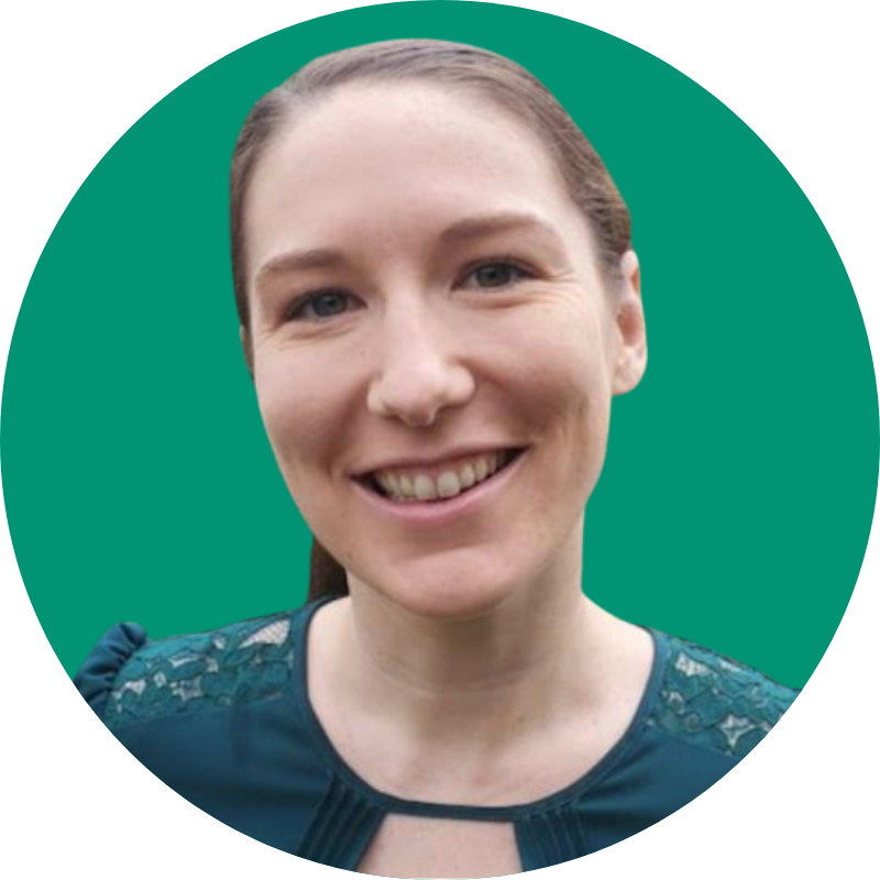 A headshot of Michaela McGuire in front of a green backdrop