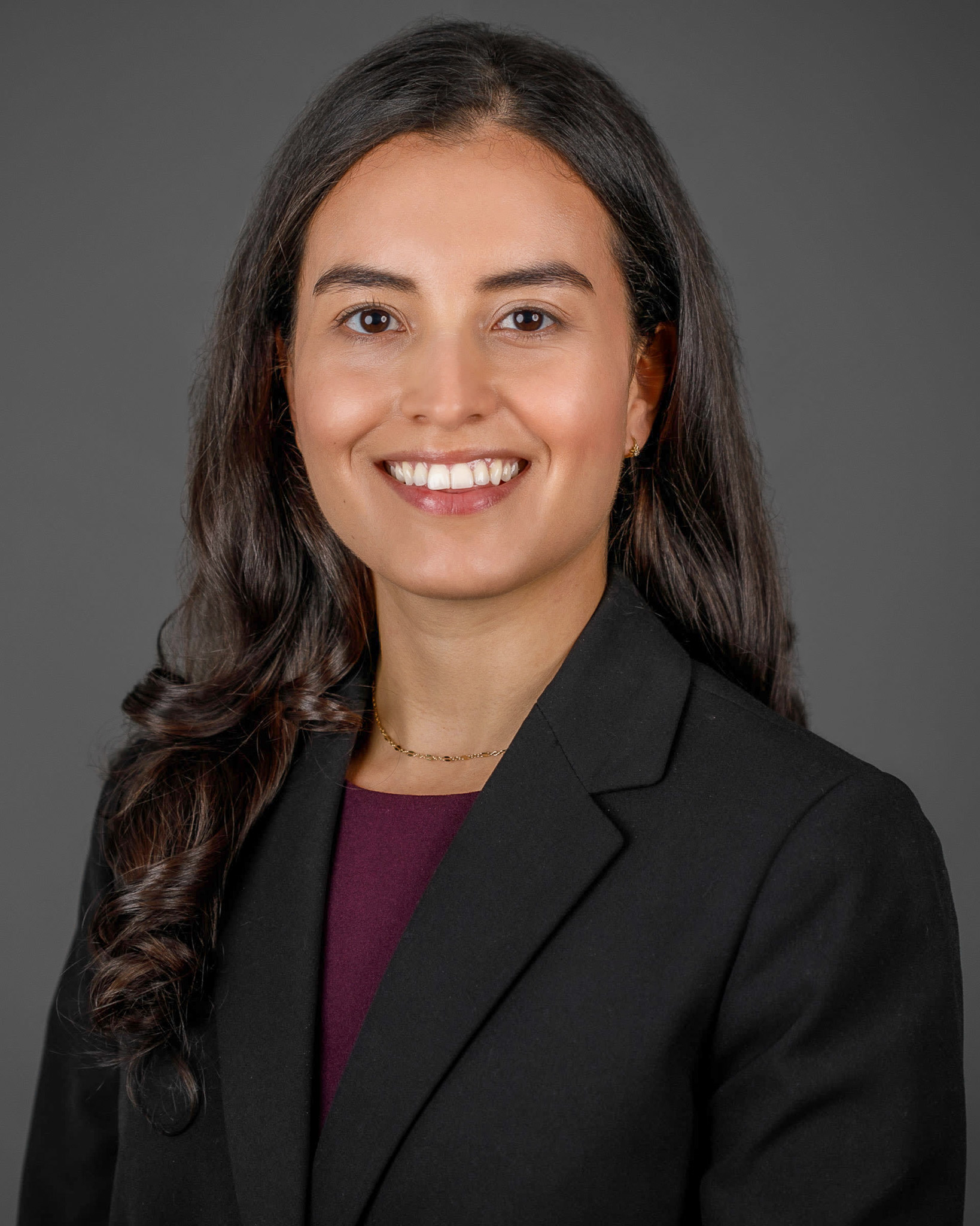 headshot of Penuela in women's suit 