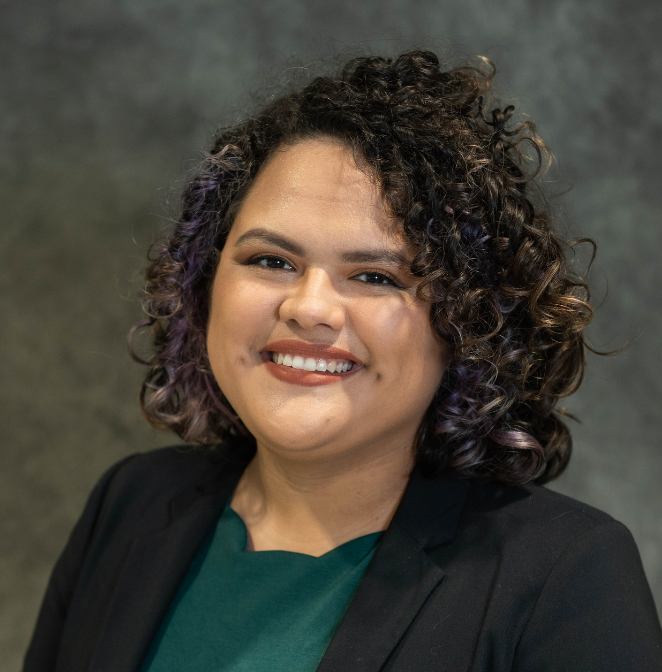 Headshot of Cassandra Garza in front of a dark grey backdrop