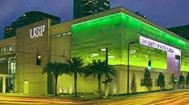 Green lights illuminating a building with wording along the side that reads: USF Health Center for Advanced Medical Learning