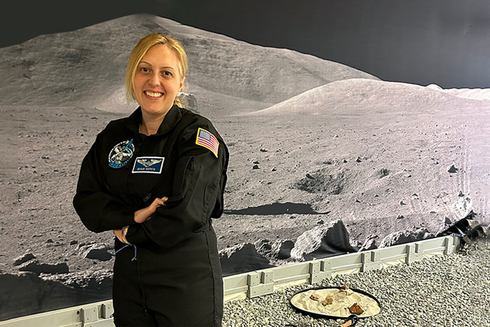 Portrait of Dr. Begum Mathyk in front of an outter space terraine landscape