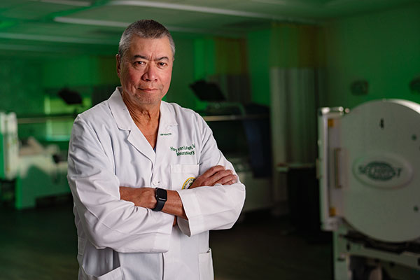 Portrait of Harry van Loveren, MD, chair of the USF Health Department of Neurosurgery and Brain Repair, standing in a research lab