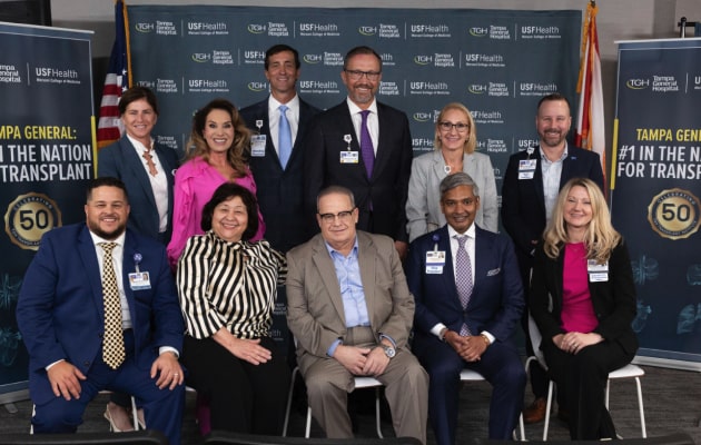 Large group photo of USF Health and Tampa General Hospital Surgeons on stage.